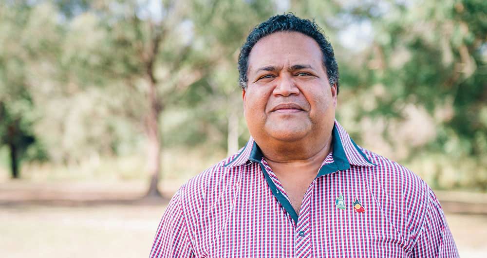 Aboriginal man standing outside