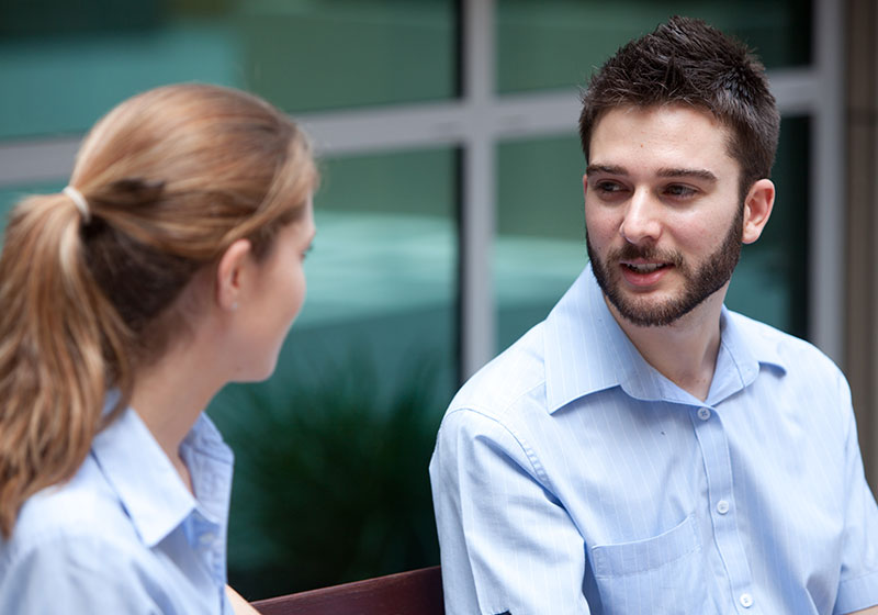 two staff members mid conversation