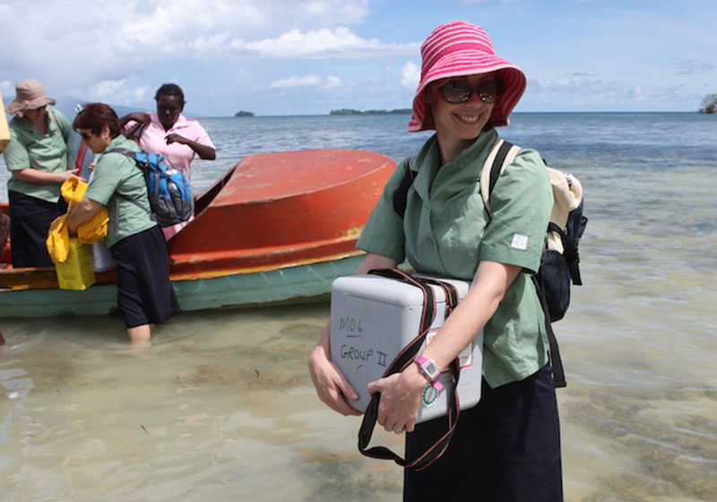 happy woman standing in ocean helping out
