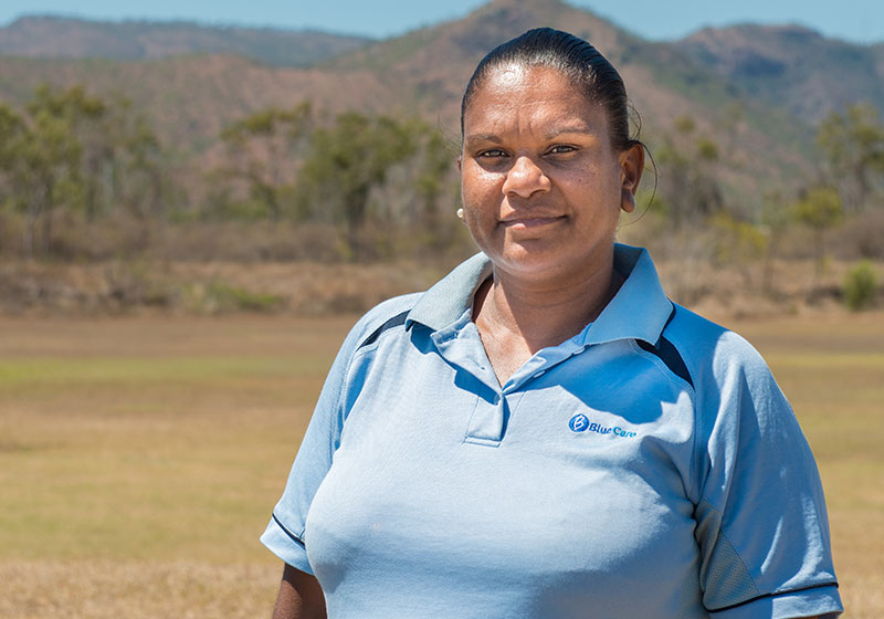 blue care employee in blue shirt smiling