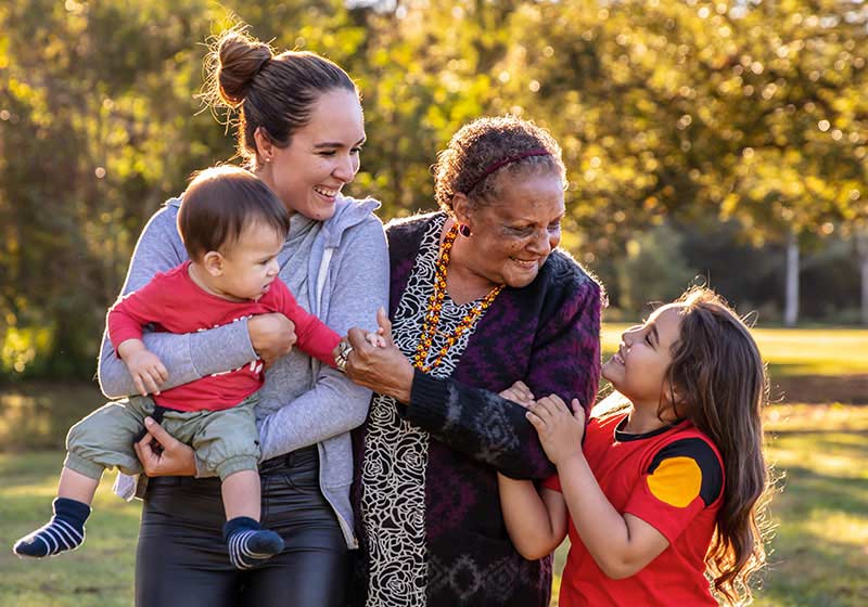 aboriginal family having fun outside in the sun