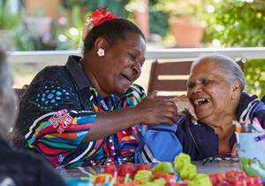 indigenous man in pink button up standing outside