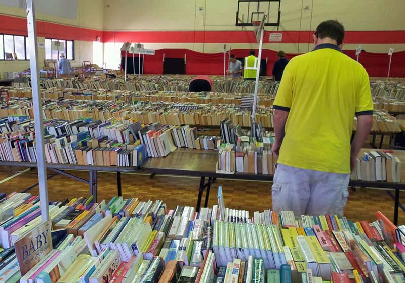 a man browsing a store filled with books