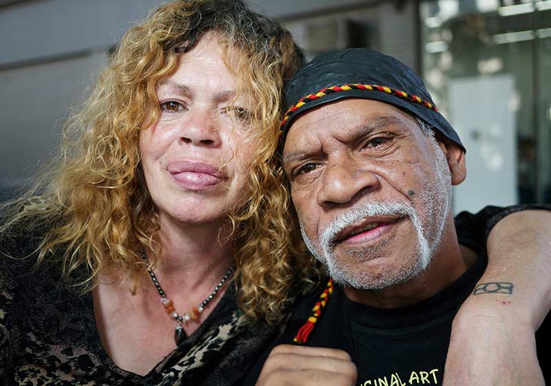 Close up of a man and a woman looking to the camera