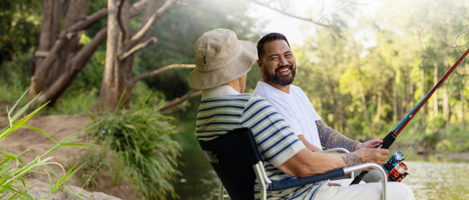 Father and son fishing together at a lake