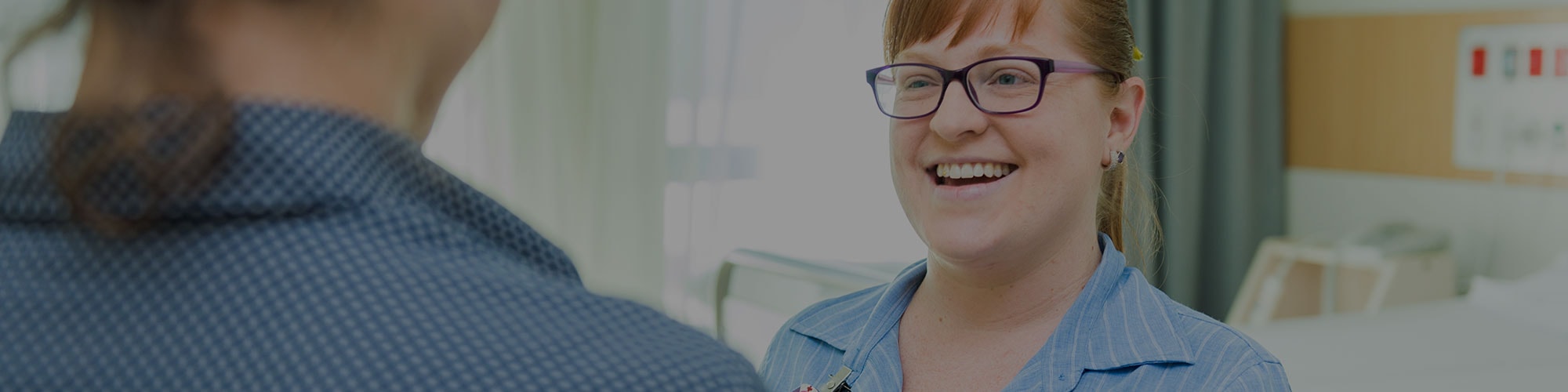 young female staff member smiling in coversation