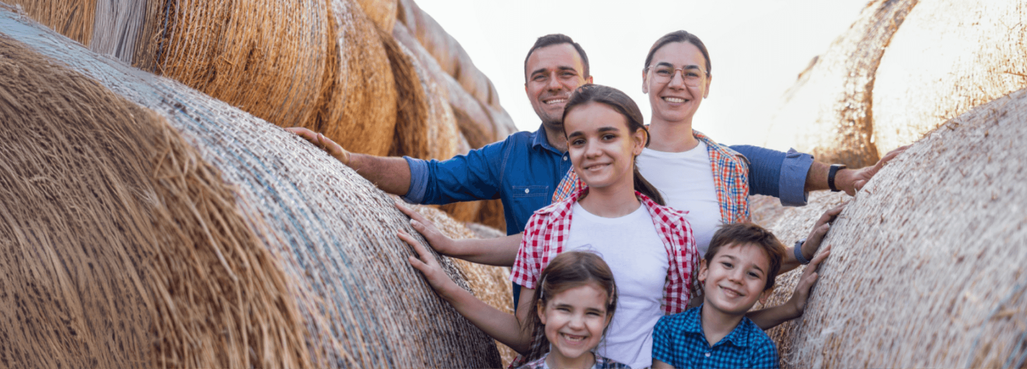 Outback family posing in some hay bales