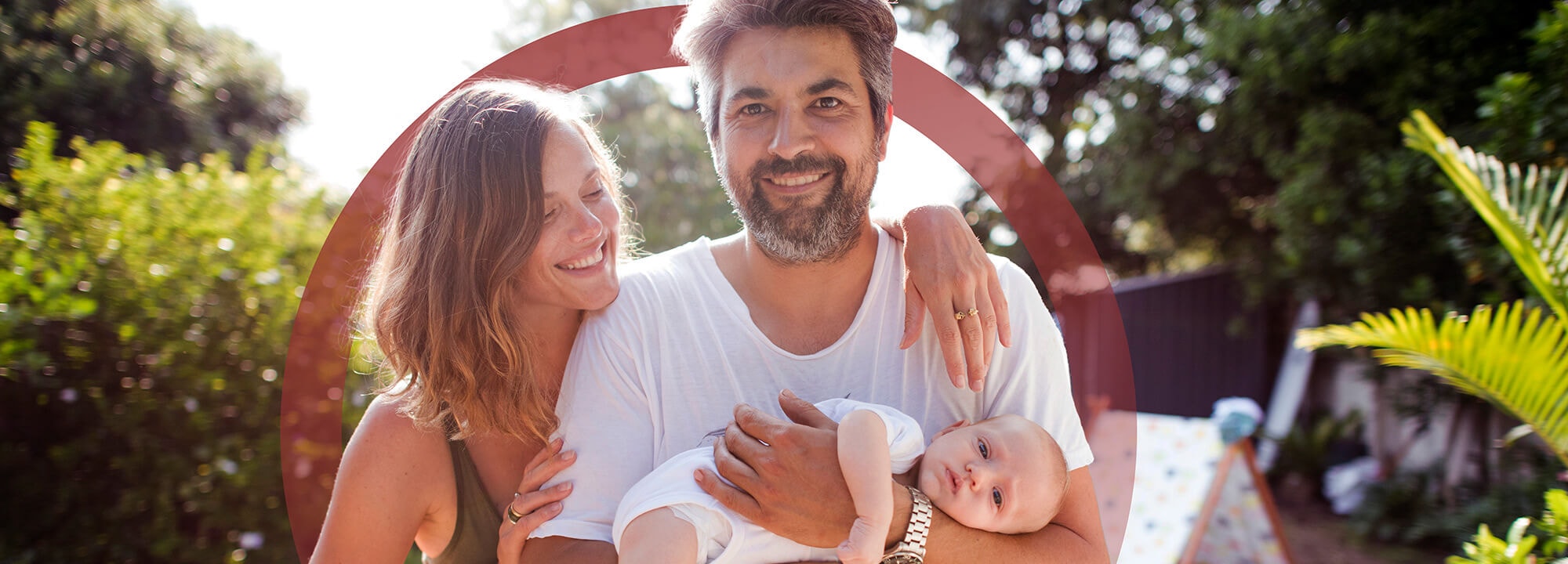 Happy young woman and man holding a baby